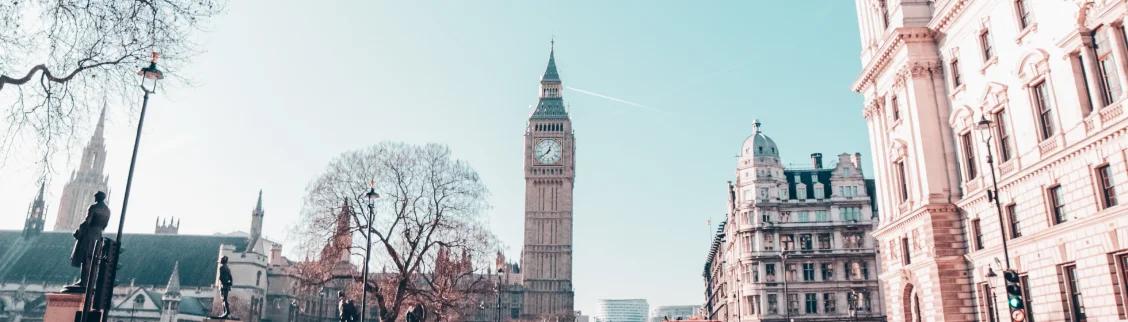 Big Ben clock tower and Westminster architecture in London with bare winter trees and historic buildings