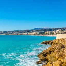 Stunning Mediterranean coastline of Nice with turquoise waters and rocky cliffs under clear blue sky