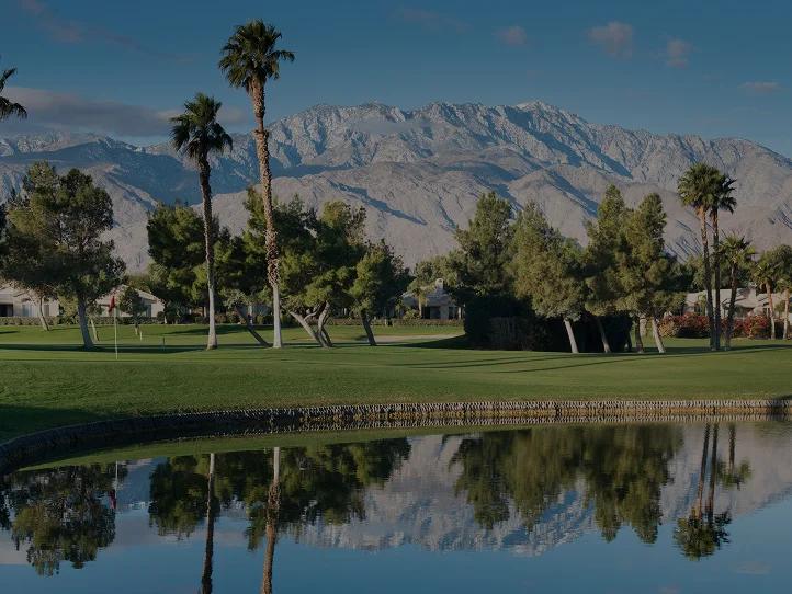 Pristine golf course fairway in Palm Springs with snow-capped San Jacinto Mountains backdrop
