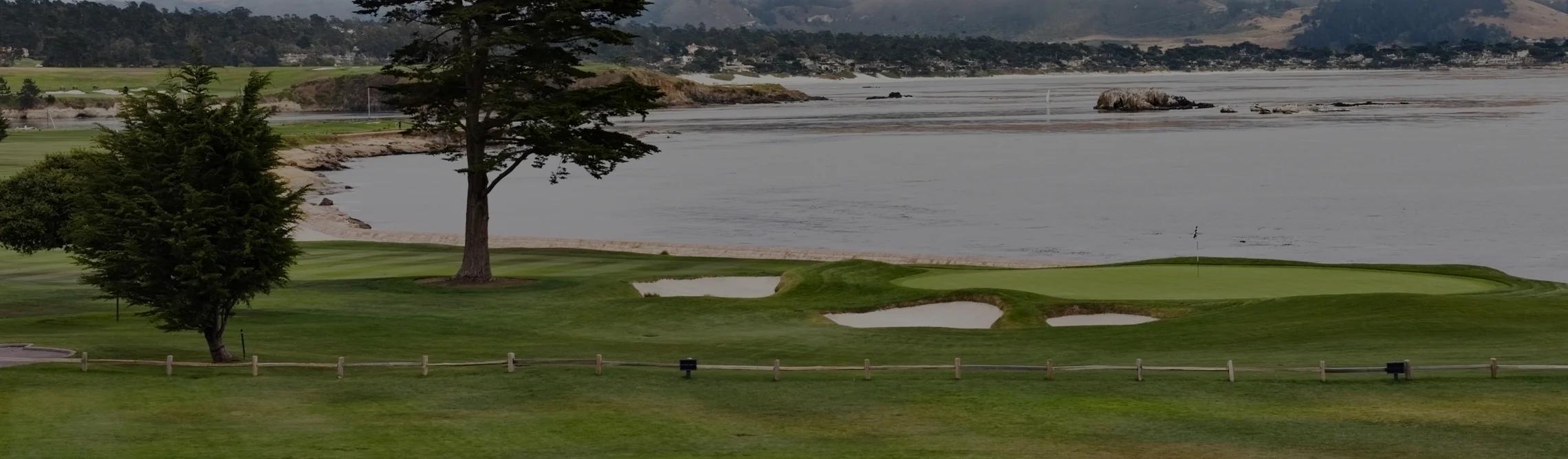 Pebble Beach golf course with pristine fairways, sand bunkers, and scenic Pacific Ocean coastline