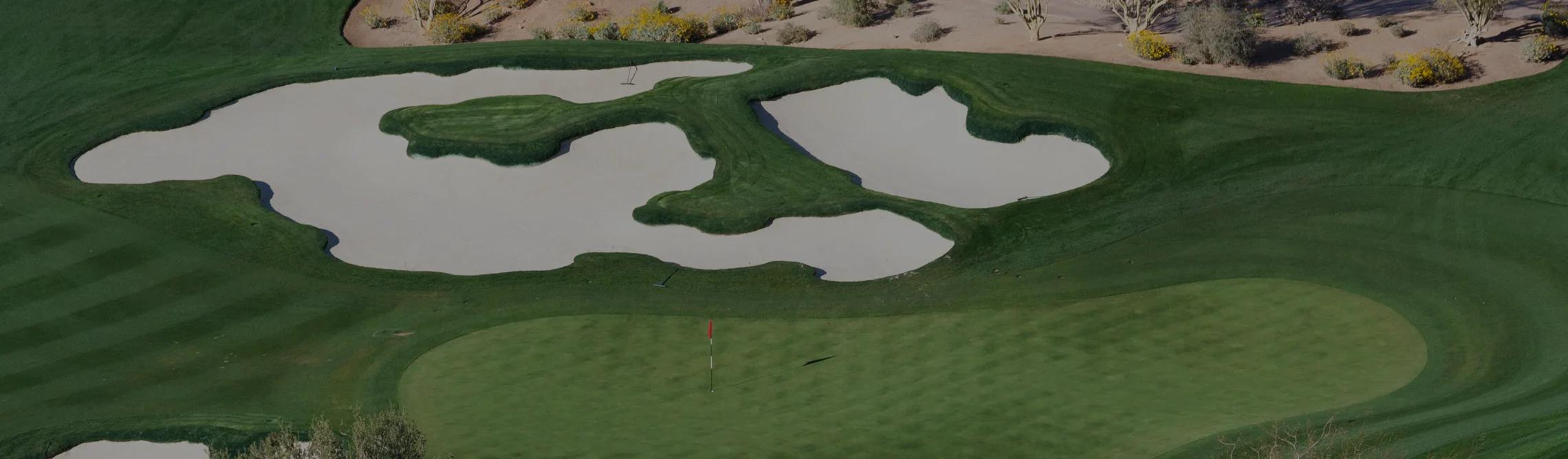 Pristine desert golf course in Scottsdale with manicured greens, sand bunkers and desert landscape