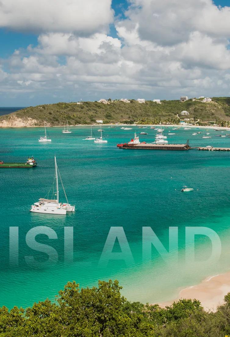 Pristine turquoise bay in Anguilla with white sand beach, luxury yachts anchored in crystal waters