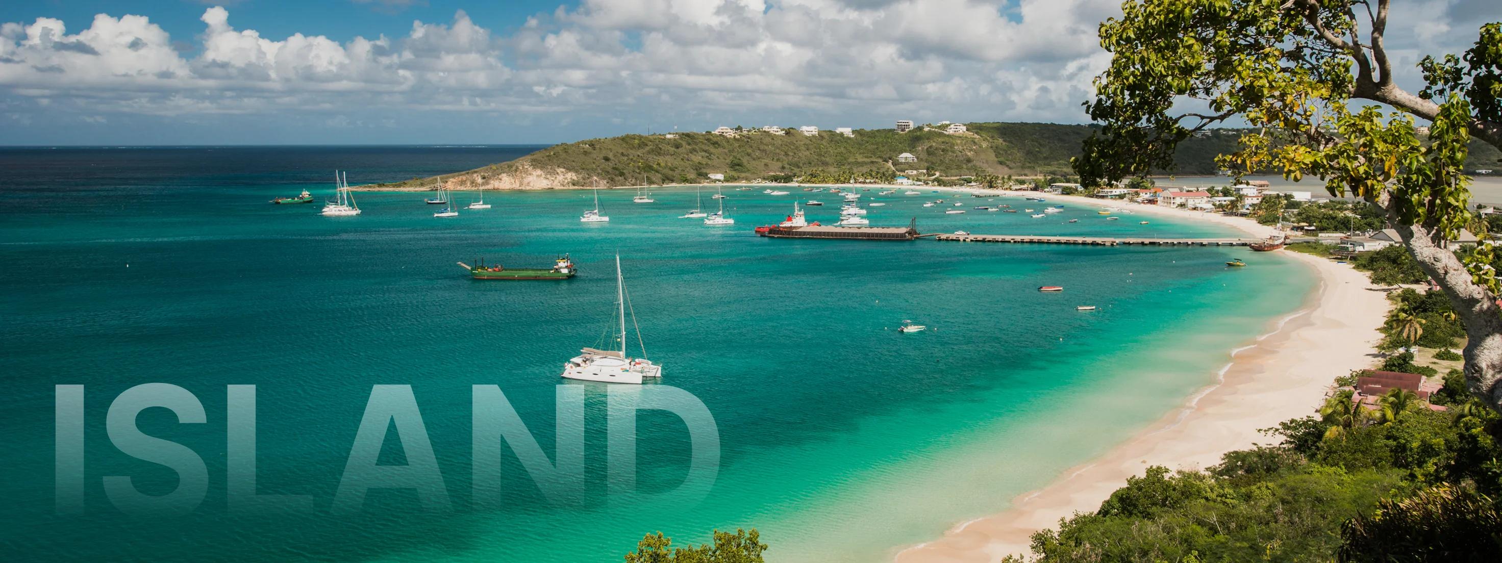 Pristine turquoise bay in Anguilla with white sand beach, luxury yachts anchored in crystal waters