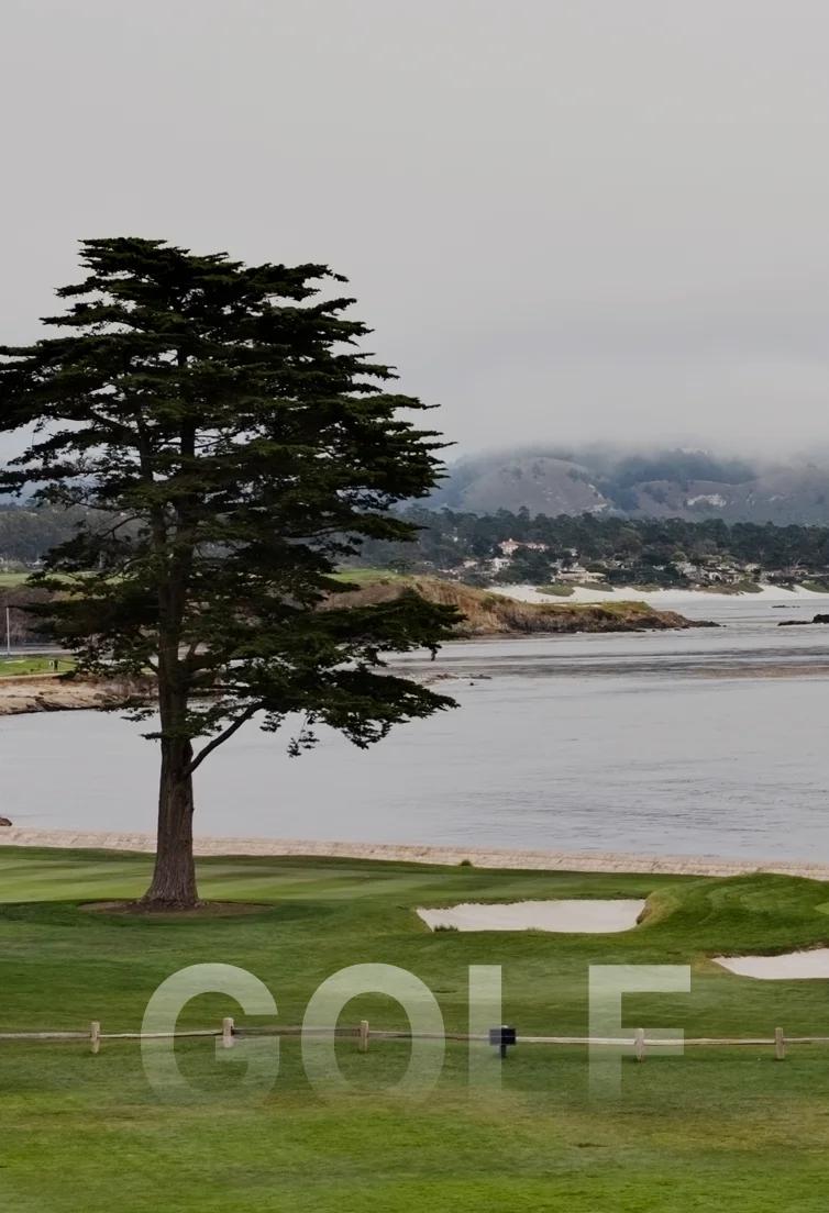 Scenic Pebble Beach golf course with pristine green fairways, sand bunkers, and Pacific Ocean coastline