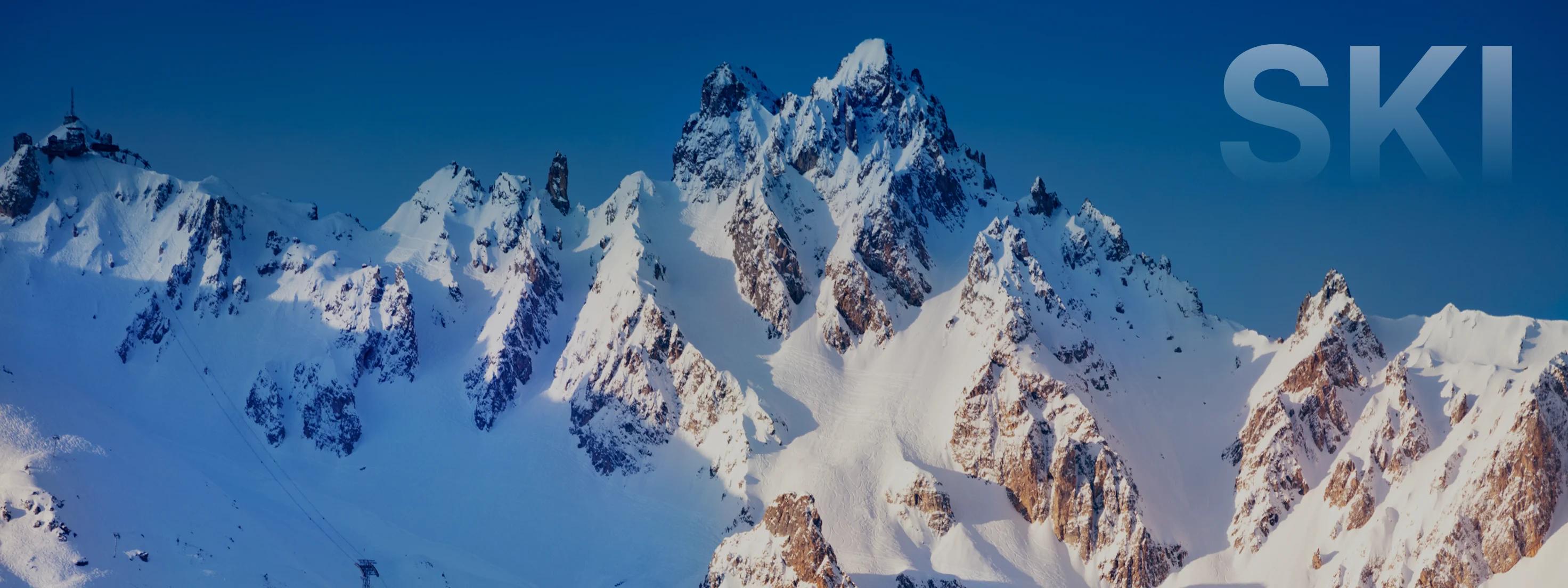 Snow-covered mountain peaks and alpine ridges under clear blue skies in Sun Valley ski destination