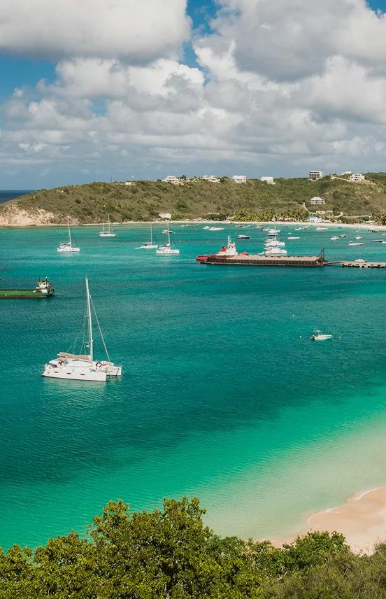 Pristine turquoise waters and white sand beach of Anguilla with luxury yachts anchored in protected bay