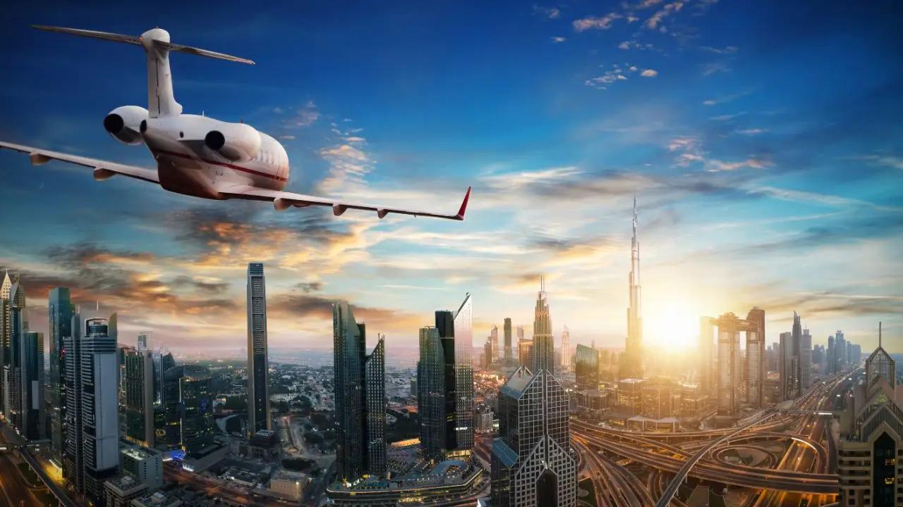 Luxury private jet soaring above Dubai's illuminated skyline at sunset, showcasing premium charter travel