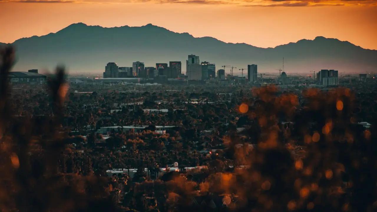 Phoenix skyline at sunset with mountains backdrop showcasing luxury travel destination for private jet charters