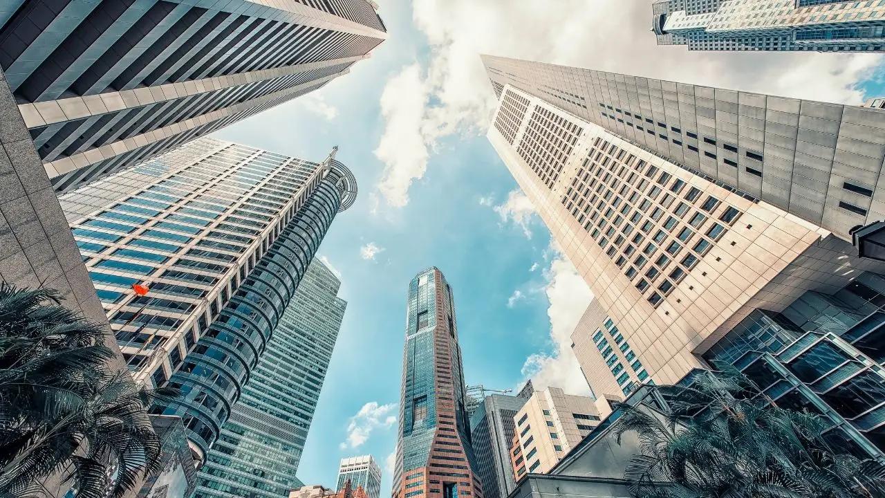 Towering skyscrapers in Singapore's financial district reaching toward blue sky, symbolizing luxury destinations